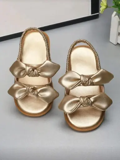 Sandalias doradas con doble lazo